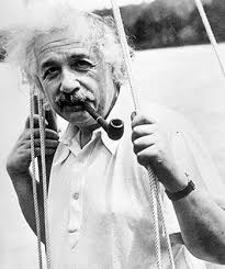 A man holding a pipe in his mouth.